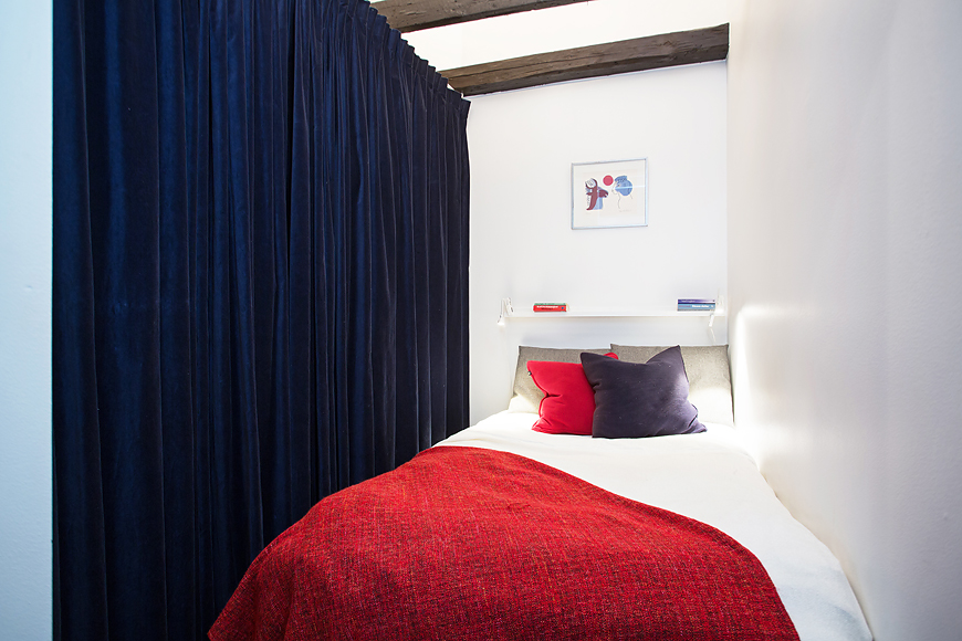 red-bed-cover-for-small-attic-apartment-bedroom-plus-white-sheet-and-blue-curtain-divider-ideas